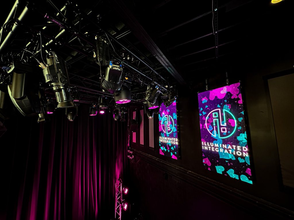 A Stage System With Screens Reading Illuminated Integration.