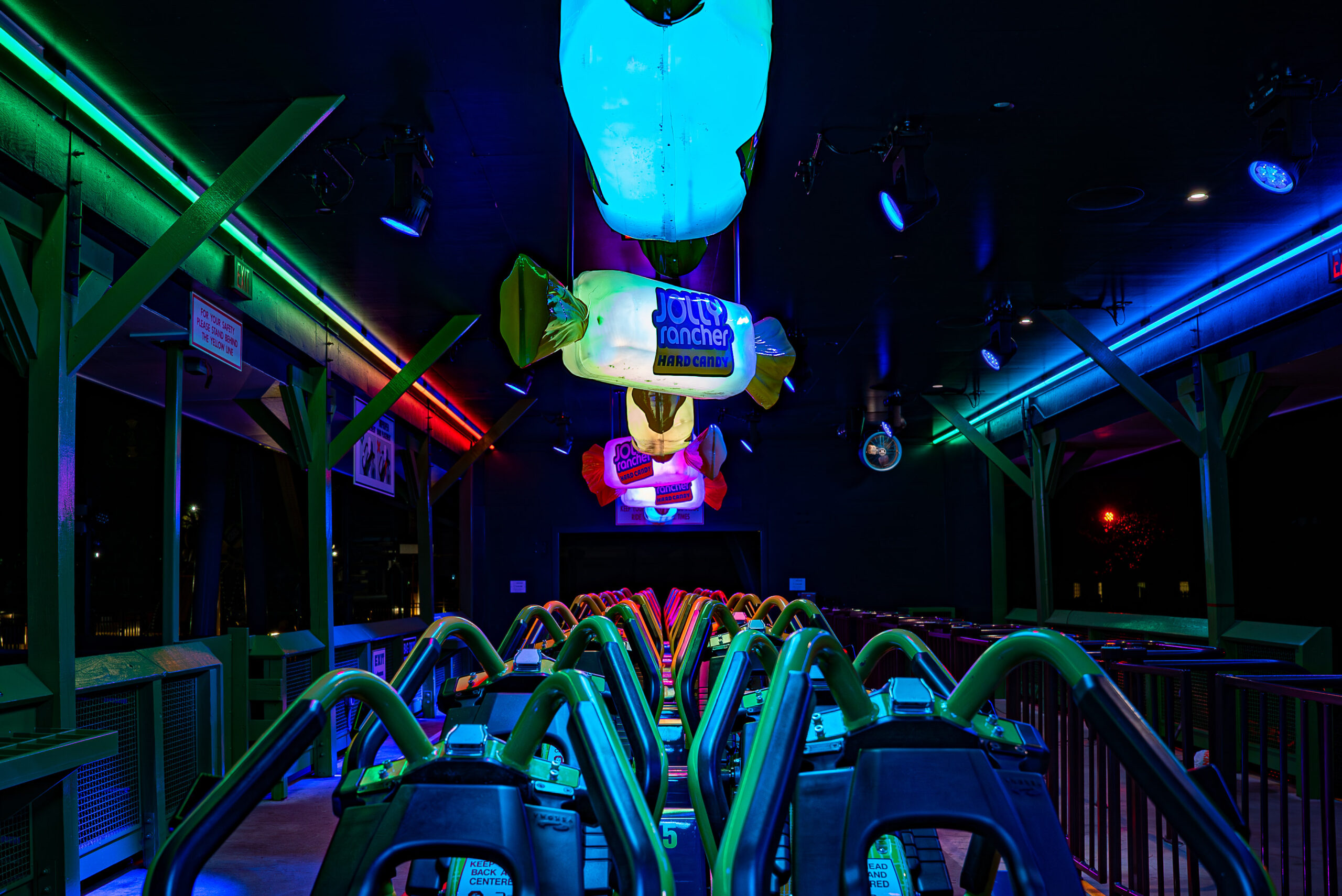 An Amusement Park Ride With Giant Lit Up Neon Jolly Ranchers