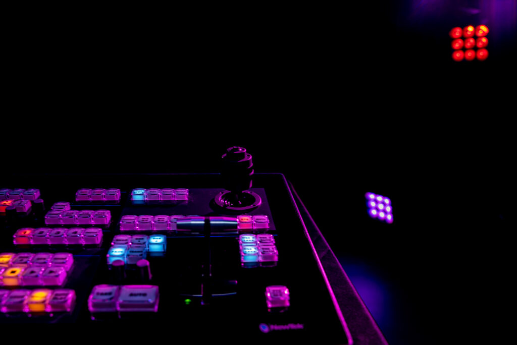 A Sound Board System In A Dark Room With Neon Lighting.