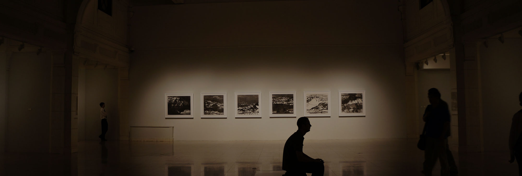 Inside Of A Art Museum With Photographs On The Wall.